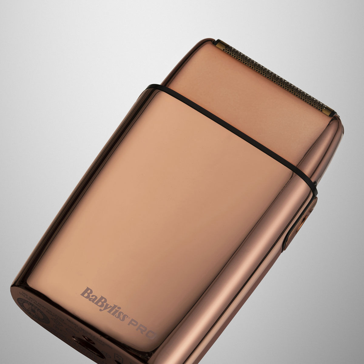 Cordless Rose Gold Foil Shaver laying down with cap removed